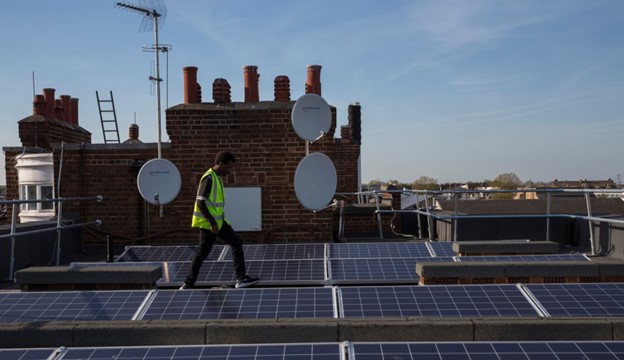 Man walking on a community-owned solar rooftop