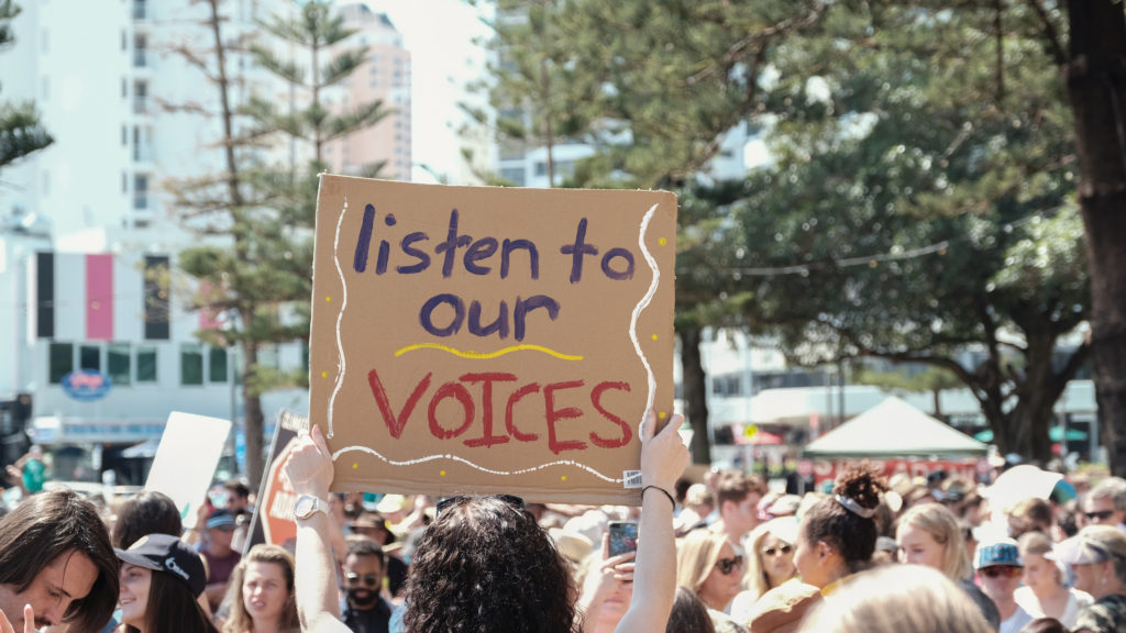 Listen to our voices placard - student march