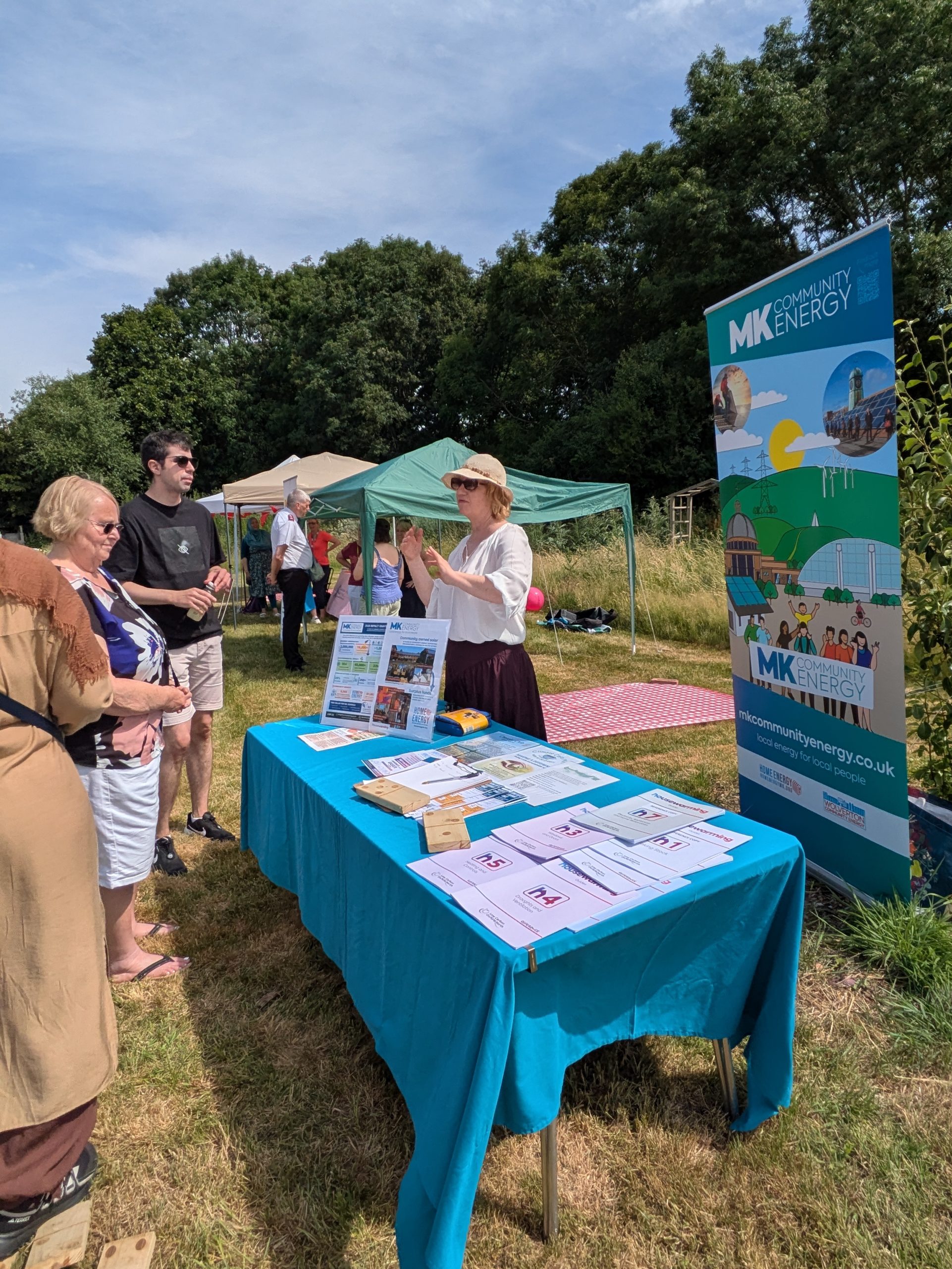 GGT Community Picnic stall - Jane talking with attendees talking with MK Community Energy